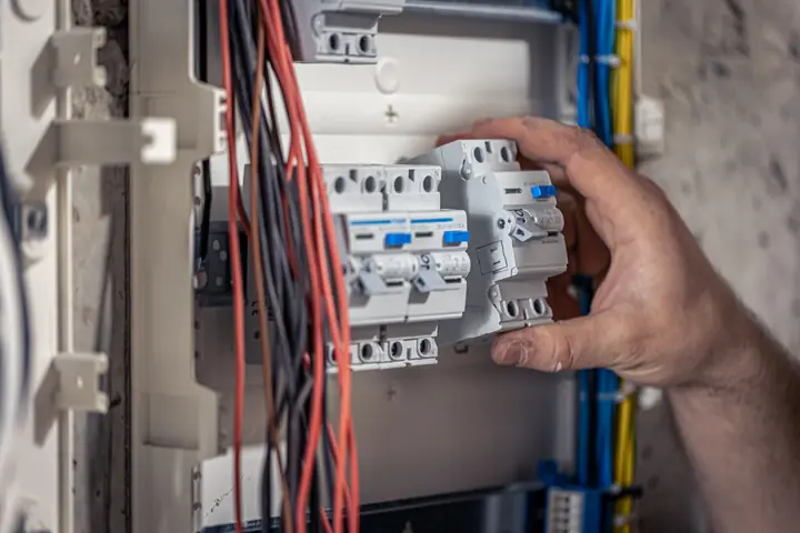 Electrical DB board breaker and protection work Close-up of an electrician replacing protection inside a DB board